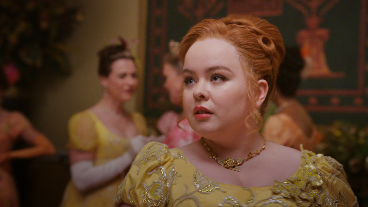 Nicola Coughlan as Penelope Featherington wears a yellow gown at a ball in season 3 of 'Bridgerton'