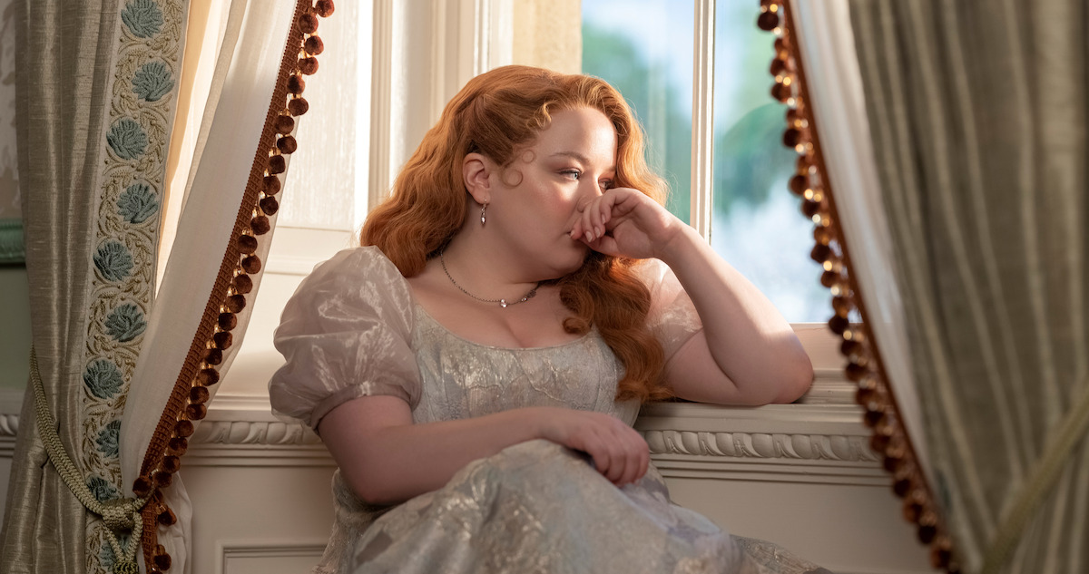  Nicola Coughlan as Penelope Featherington sits by a window in season 3 of 'Bridgerton'