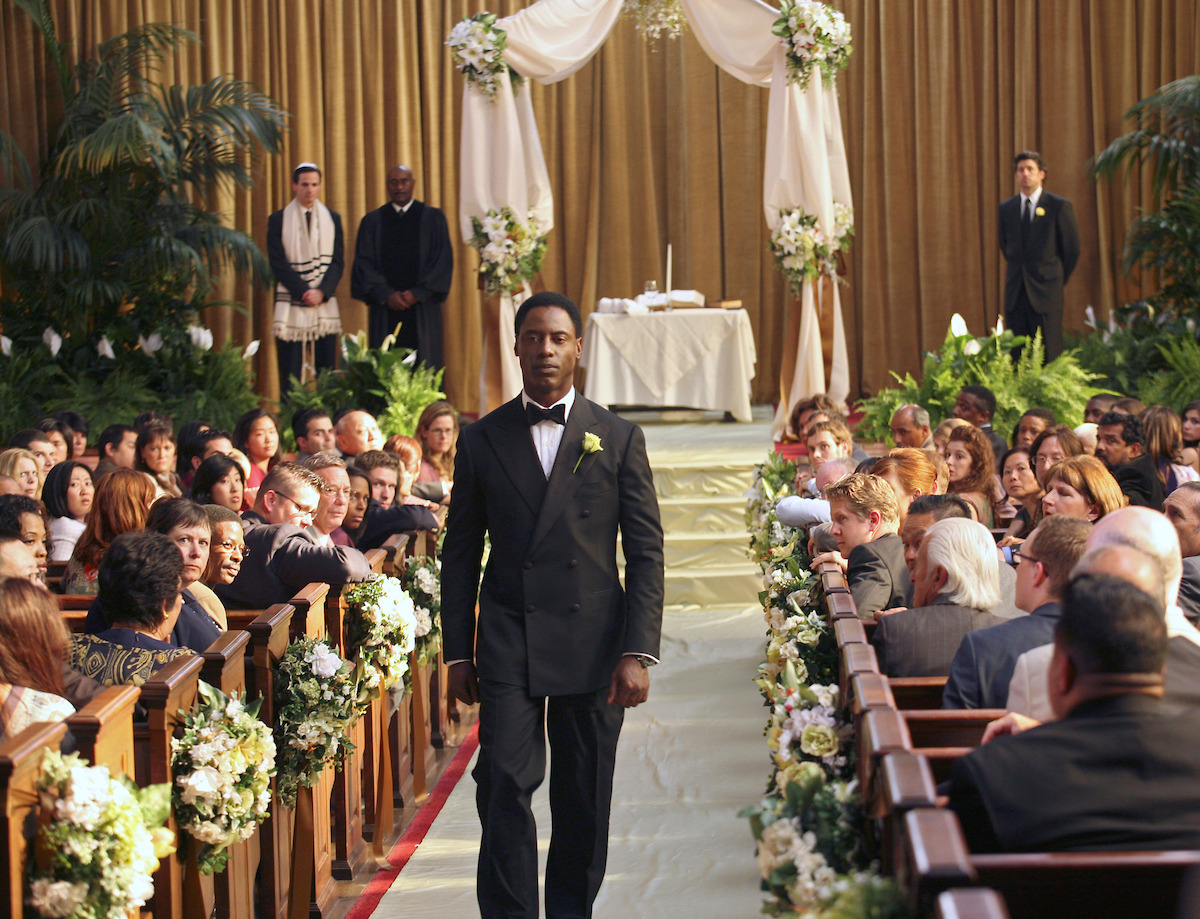 A groom walks down the aisle, without his bride.