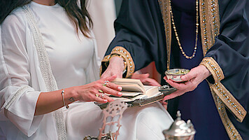 A man and woman flipping through the pages of a book 