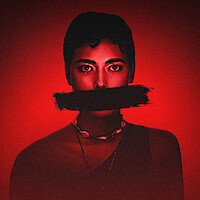 A red hue over a woman with a wide black line painted over her mouth for 'Colors of Evil: Red'