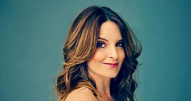 Headshot of Tina Fey against a blue background 