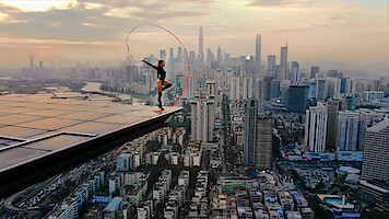 Angela Nikolau performing on top of a building.