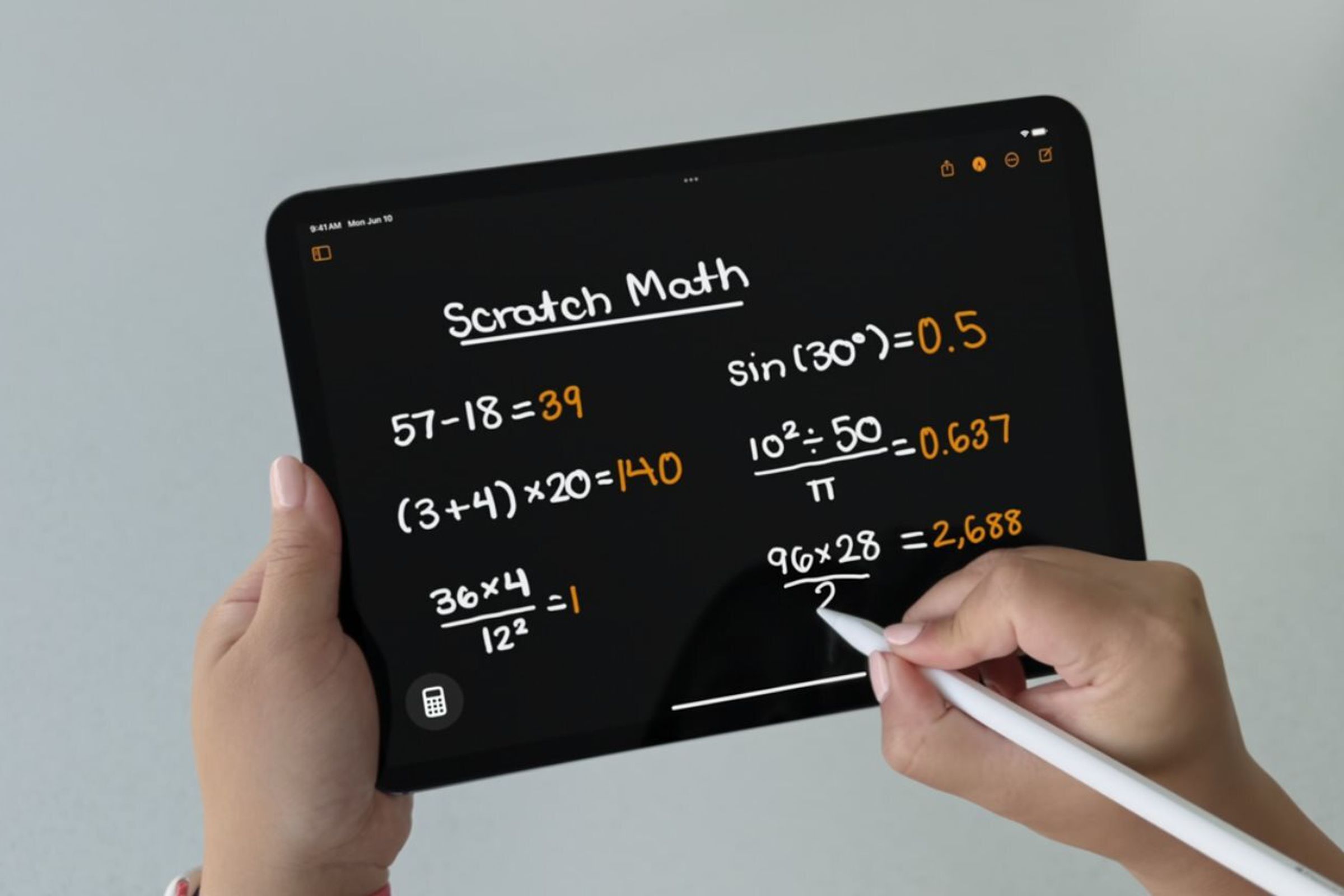 A person uses Apple’s Calculator app for iPad with their Apple Pencil.