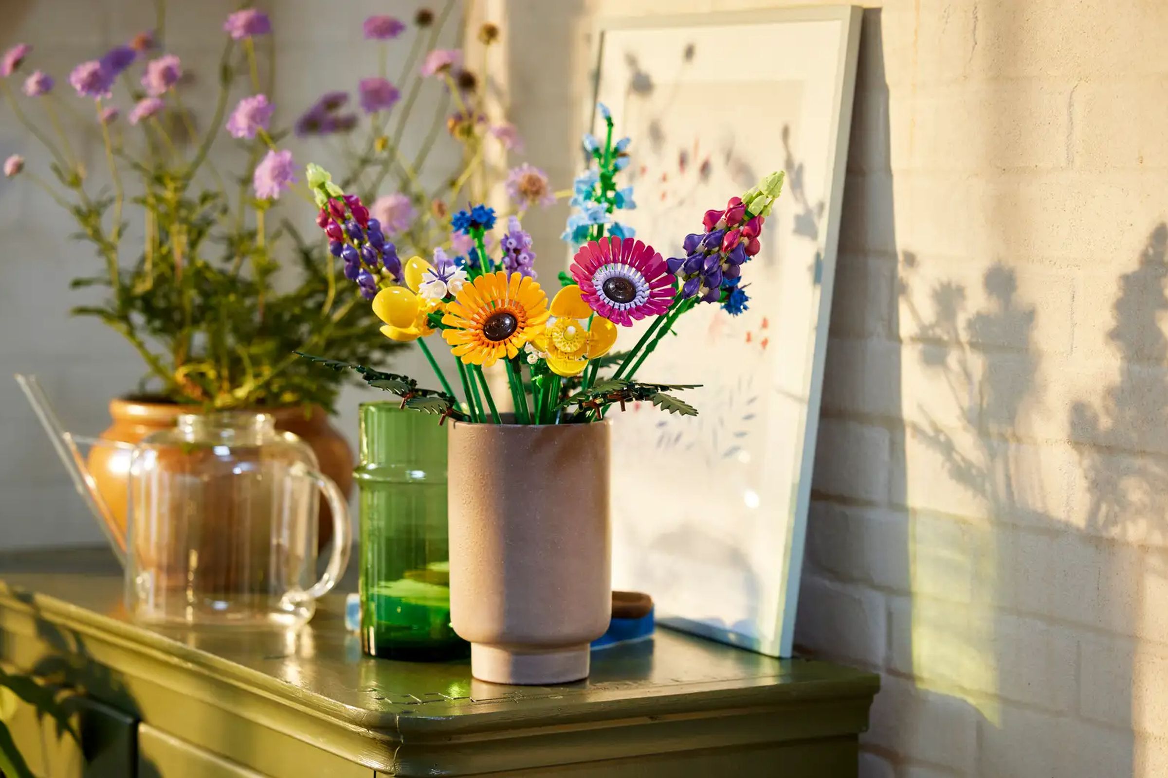 A wildflower bouquet made of Legos sitting on a cabinet.