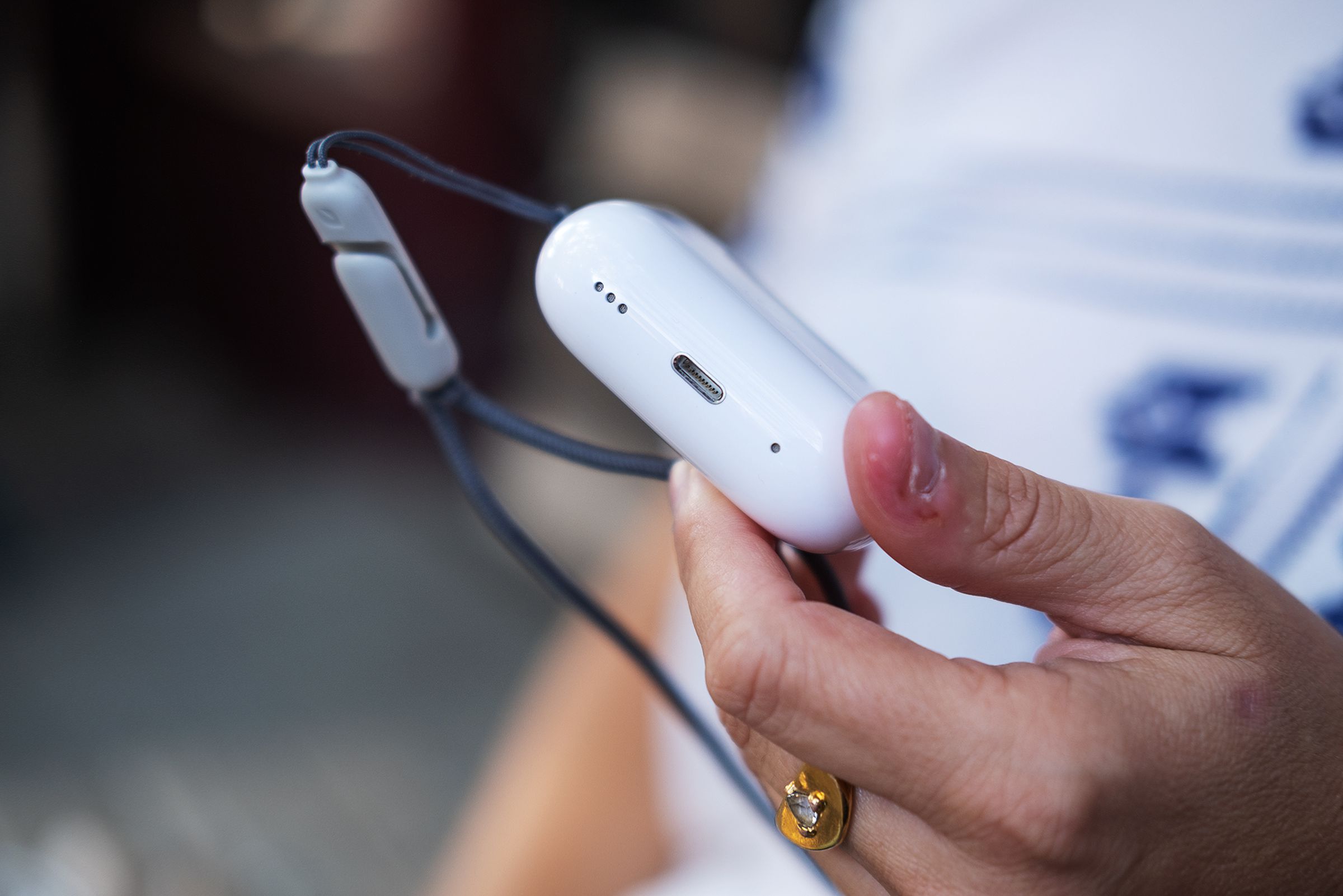 A close-up photo of the case for Apple’s second-generation AirPods Pro. The new speaker is pictured.