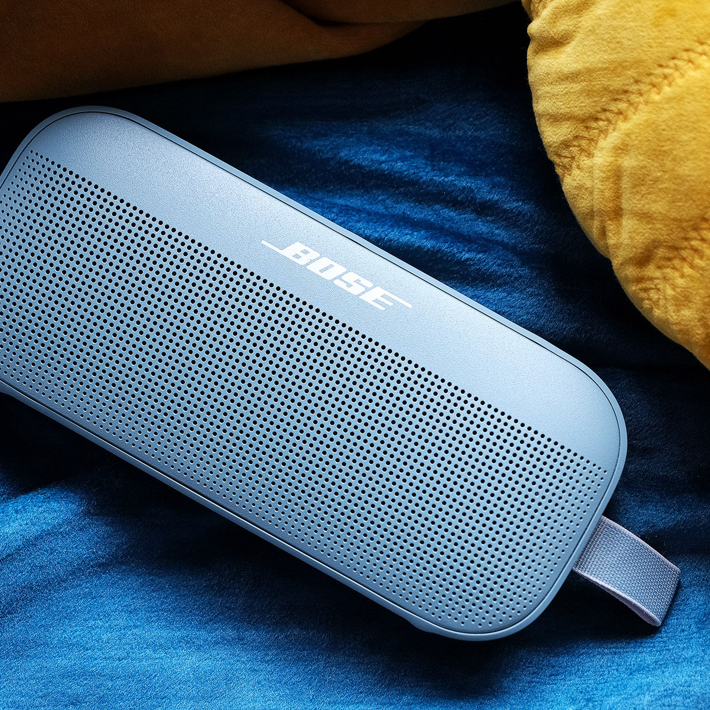 The Bose SoundLink Flex, resting on a blanket.