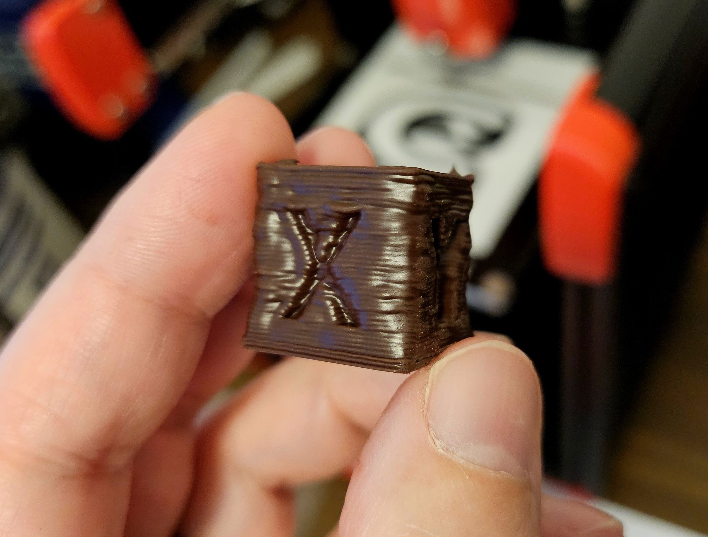 A very lumpy, too-smooth calibration cube. The glossy layers didn’t have enough time too cool.