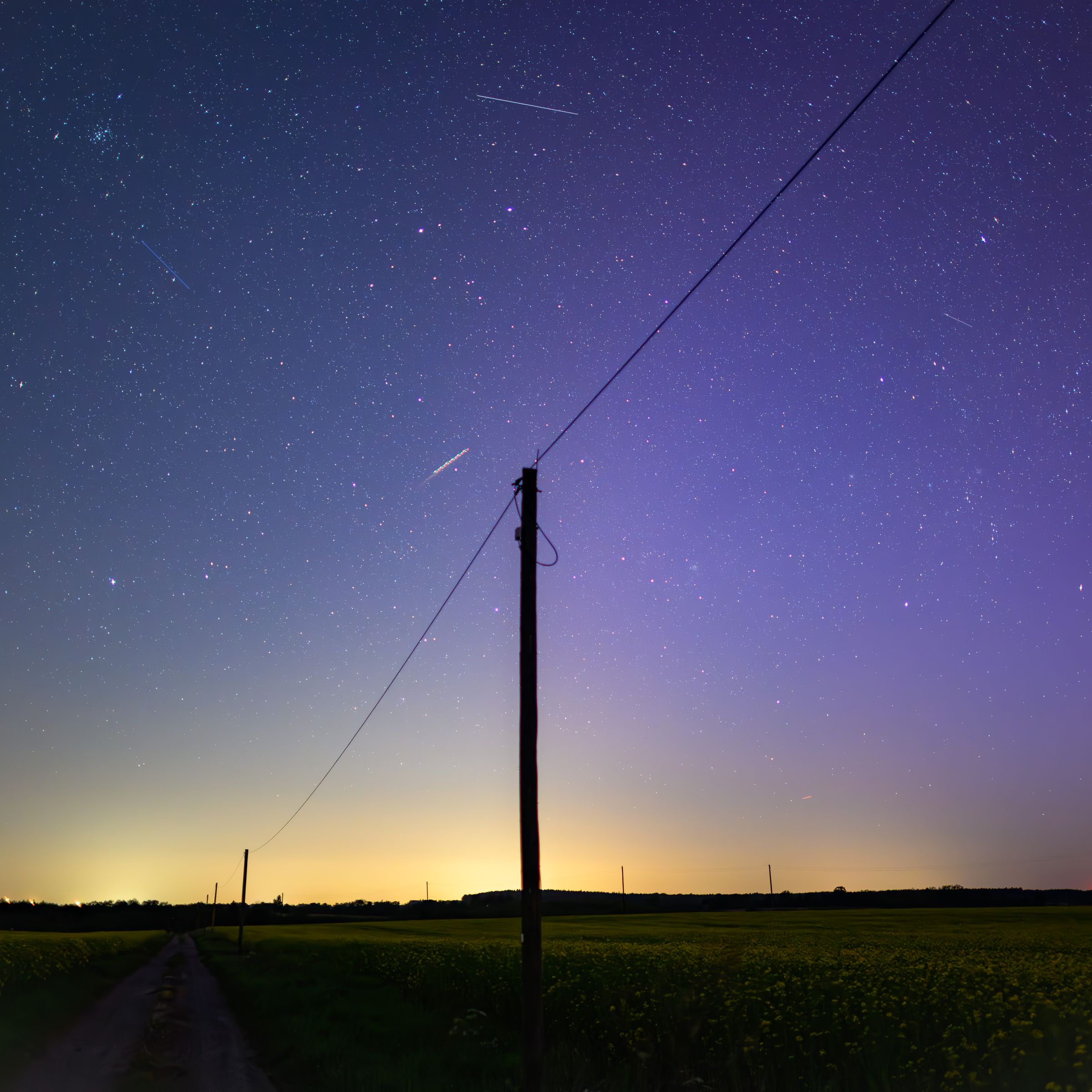 A power line against a purple night sky.