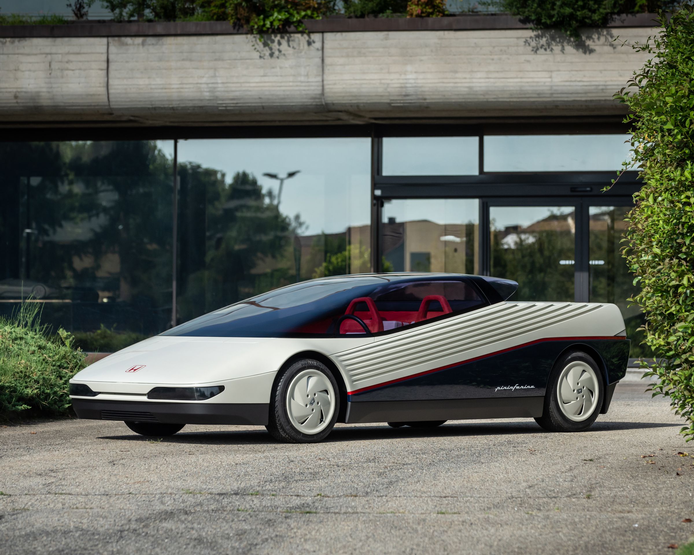 Wedge-shaped concept car photographed in front of a building