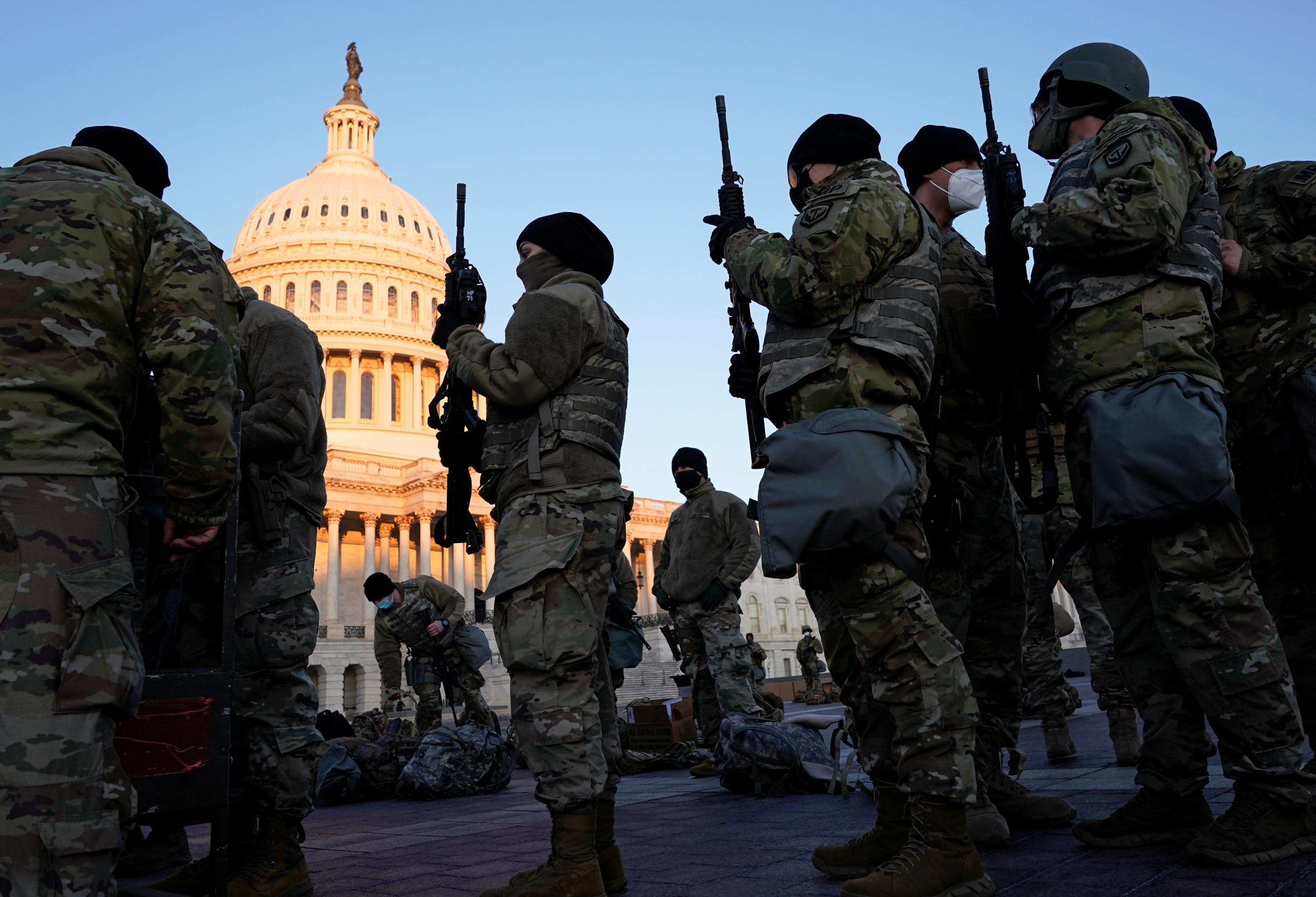 Members of the National Guard are given weapons before Democrats begin debating one article of impeachment against President Trump, outside the US Capitol in Washington, DC, on Wednesday, January 13.