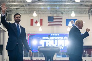 Republican vice presidential candidate Sen. JD Vance, R-Ohio, waves as Republican presidential candidate former President Donald Trump pumps his fist at a campaign rally, Saturday, July 27, 2024, in St. Cloud, Minn.