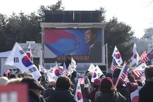 A picture of impeached South Korean President Yoon Suk Yeol is seen on the screen during a rally in Uiwang, South Korea