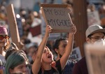 Abortion protests (Roe v Wade): A woman protesting holding a banner