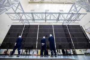 Technicians examine the first of two fully extended five-panel solar arrays built for NASA’s Europa Clipper suspended on a support system called a gravity offload fixture during inspection and cleaning as part of assembly, test, and launch operations inside the Payload Hazardous Servicing Facility at the agency’s Kennedy Space Center in Florida on Wednesday, March 6, 2024. Another name for the gravity offload fixture is the Transportable Large Envelope Deployment Facility (T-LEDF). When both solar arrays are installed and deployed on Europa Clipper – the agency’s largest spacecraft ever developed for a planetary mission – the spacecraft will span a total length of more than 100 feet and weigh 7,145 pounds without the inclusion of propellants.