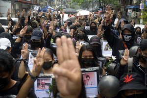 Anti-coup protesters flash three-fingered symbol of resistance as they gather to pray for those who died during a protest against the military in Yangon, Myanmar, Monday, April 5, 2021.