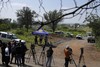 Journalists are seen during a stake-out at an abandoned gold mine, where miners were rescued from below ground, in Stilfontein, South Africa