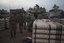 Israeli soldiers from the artillery unit store tank shells in a staging area at the Israeli-Gaza border in southern Israel, Monday, Jan. 1, 2024