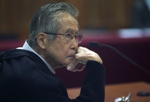 FILE - Peru's jailed, former President Alberto Fujimori, photographed through a glass window, attends his trial at a police base on the outskirts of Lima, Peru, June 28, 2016.