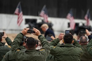 Border Patrol Officers take photos of President Donald J. Trump as he arrives to deliver remarks at the 450th mile of the new border wall Tuesday, Jan. 12, 2021, near the Texas Mexico border