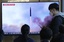 A TV screen shows a file image of North Korea's missile launch during a news program at the Seoul Railway Station in Seoul, South Korea, Thursday, March 16, 2023.