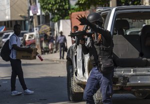 Police stop at a car to inspect in Port-au-Prince, Haiti, Monday, April 22, 2024.