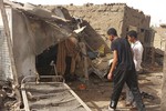 File - People check the rubble of their destroyed home after strikes at Allamat district in Khartoum, Sudan, Thursday, June 1, 2023.  The White House says it's imposing sanctions against key defense companies and people who “perpetuate violence” in Sudan as the warring sides fail to abide by a cease-fire agreement in the northeastern African nation.