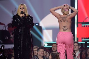 A protestor interrupts Avril Lavigne speaking onstage at the 2023 JUNO Awards at Rogers Place on March 13, 2023 in Edmonton, Canada.