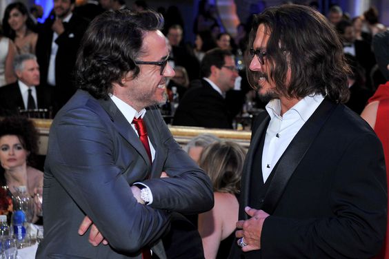 Robert Downey Jr., Johnny Depp during the 68th Annual Golden Globe Awards held at the Beverly Hilton Hotel on January 16, 2011