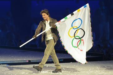 PARIS, FRANCE - AUGUST 11: Tom Cruise carries the Olympic Flag during the Closing Ceremony of the Olympic Games Paris 2024 at Stade de France on August 11, 2024 in Saint-Denis near Paris, France. 