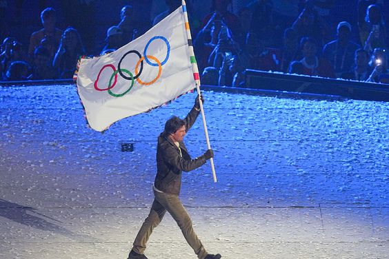 12 August 2024, France, Paris: Olympia, Paris 2024, Stade de France, US actor Tom Cruise holds the Olympic flag during the closing ceremony.