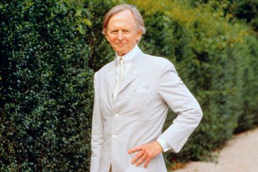 Novelist Tom Wolfe Standing by Hedge