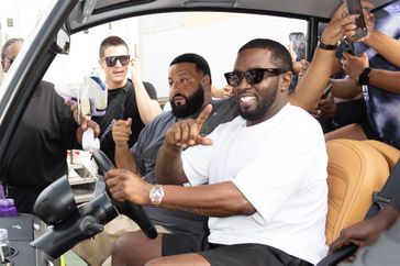 Sean "Diddy" Combs and Dj Khaled arrive in a golf kart to support the J Balvin x Air Jordan 3 Retro PS ‘Medellín Sunset at We The Best x Snipes store on September 29, 2023 in Miami Beach, Florida.