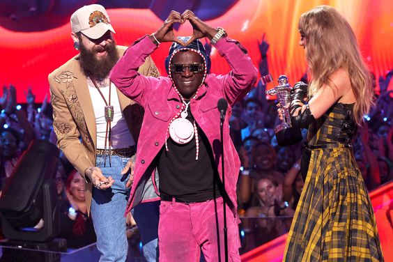 Post Malone and Taylor Swift accept the Best Collaboration award for "Fortnight" from Flavor Flav (C) on stage during the 2024 MTV Video Music Awards at UBS Arena on September 11, 2024 in Elmont, New York.