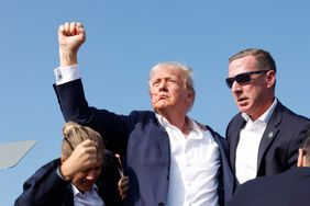  Republican presidential candidate former President Donald Trump is rushed offstage during a rally on July 13, 2024 