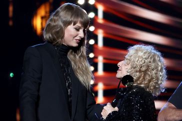 Taylor Swift inducts Carole King onstage during the 36th Annual Rock & Roll Hall Of Fame Induction Ceremony at Rocket Mortgage Fieldhouse on October 30, 2021 in Cleveland, Ohio.