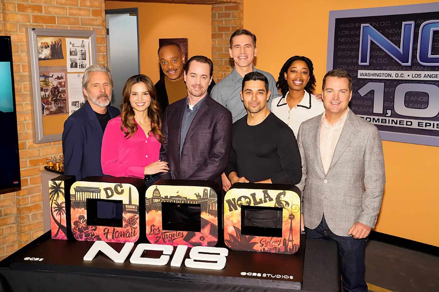 Cast of NCIS at a cake-cutting event in honor of the show's 1,000th episode. 