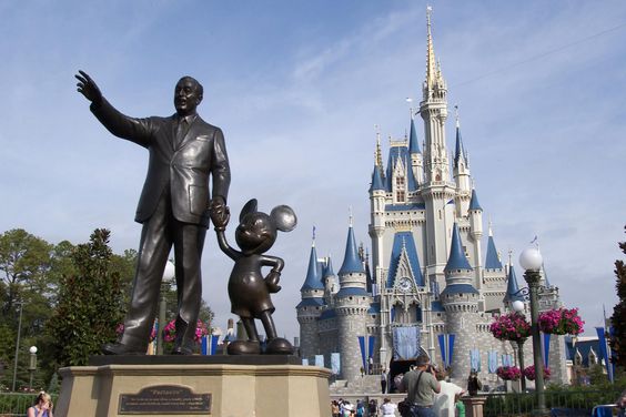 A statue of Walt Disney and Mickey Mouse stands in front of