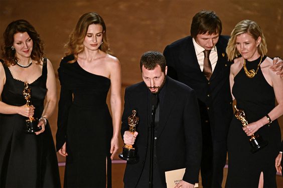Ukrainian filmmaker Mstyslav Chernov (C), flanked by (from L) Raney Aronson-Rath, Vasilisa Stepanenko, Evgeniy Maloletka and Michelle Mizner, accepts the award for Best Documentary Feature Film for "20 Days in Mariupol" onstage during the 96th Annual Academy Awards at the Dolby Theatre in Hollywood, California on March 10, 2024