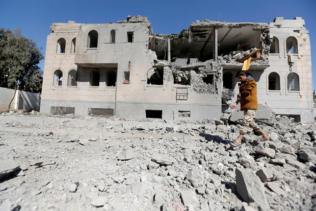 A Houthi militant walks by a Houthi-run detention center hit by air strikes in Sanaa, Yemen December 13, 2017. REUTERS/Khaled Abdullah ORG XMIT: GGGKHA20