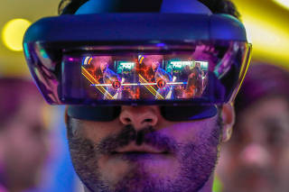 A visitor tries out Lenovo augmented reality glasses with the Star Wars Jedi Challenges during the Mobile World Congress in Barcelona,