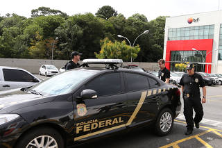 Federal Police officers leave the headquarters of the meatpacking company BRF SA in Curitiba