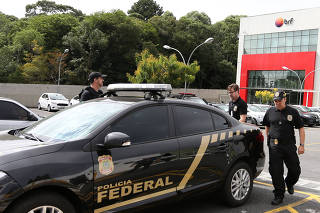 Federal Police officers leave the headquarters of the meatpacking company BRF SA in Curitiba