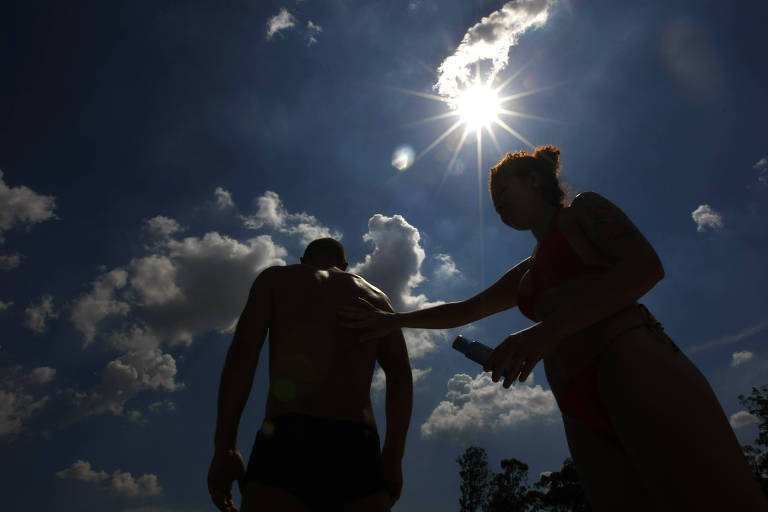 Casal passa protetor solar no parque Ibirapuera