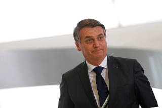 Brazil's President Jair Bolsonaro looks on during a promotion ceremony for generals of the armed forces, at the Planalto Palace in Brasilia