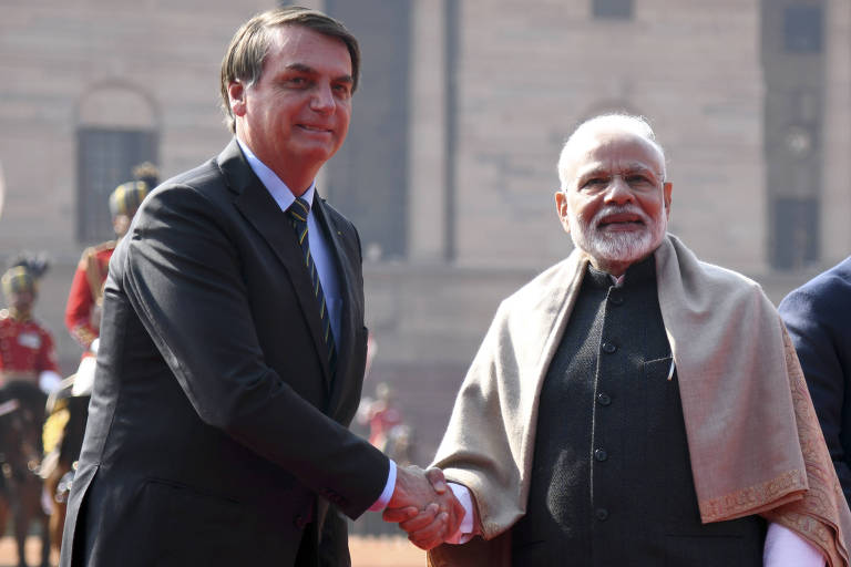 O presdiente Jair Bolsonaro, à esq., cumprimenta o premiê da Índia, Narendra Modi, durante cerimônia de recepção em Nova Déli