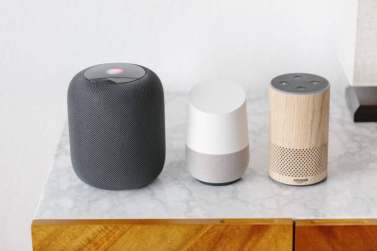 FILE -- From left, the Apple Homepod, Google Home and Amazon Alexa, Feb. 5, 2019. A Unesco report criticized the way that virtual assistants like Apple?s Siri and Amazon?s Alexa system have female names, voices and a submissive or even flirtatious style, and urged tech companies and governments to stop making them female by default. (Jason Henry/The New York Times)