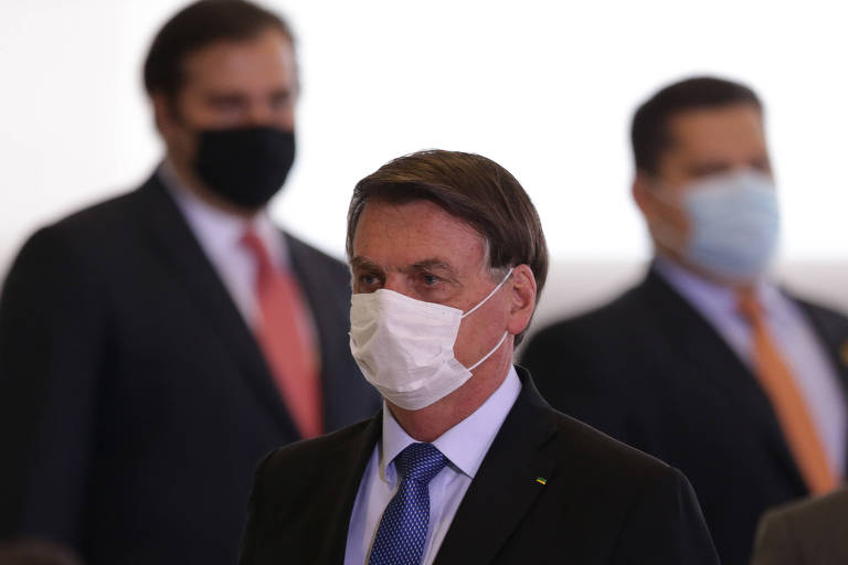 O presidente Jair Bolsonaro. No fundo, deputado Rodrigo Maia (DEM-RJ) e senador Davi Alcolumbre (DEM-AP)