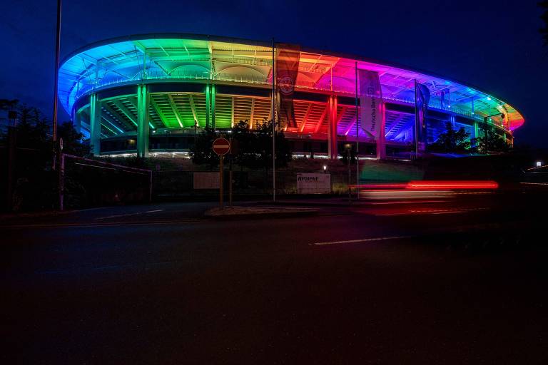 Foto noturna mostra o estádio Deutsche Bank Park é totalmente iluminado com as cores do arco-íris