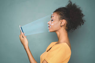 Woman with smartphone using face ID recognition system